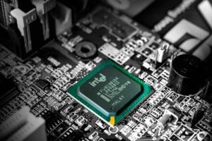 Is Intel a good stock to buy now? This close-up image of an Intel processor on a computer motherboard highlights the company's advanced semiconductor technology and market presence.
